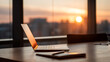 © thiago - A laptop on a wooden desk near a window, with sunset in the background.