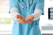 © Pixel-Shot - Male doctor holding something in clinic, closeup