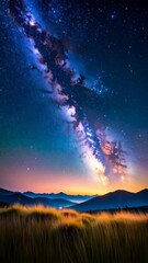 Wall Mural - Majestic milky way over tranquil mountain range at night with shooting star, landscape of golden meadow in the foreground, celestial show