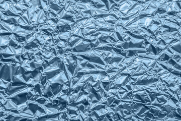 Wall Mural - shiny metallic blue foil crumpled texture background