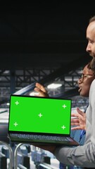 Poster - Vertical video Military command center engineering team using chroma key notebook. Army IT expert and coworkers in data center using green screen laptop to defend networks against threats, camera A