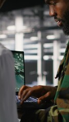 Poster - Vertical video Military IT specialists in server hub using laptop scanner tools to oversee battlefield during warfare. Army data center admins doing transmission analysis and live UAV system