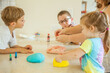 © Austockphoto - Mum making colourful play dough with her kids