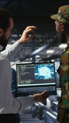 Poster - Vertical video Military technicians in secure data center use laptop to monitor artificial intelligence systems. Army operators in server hub ensuring stable infrastructure for machine learning