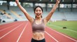 © Bang - Joyful athlete celebrating victory on track field during a sunny day