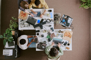 group of professionals working on modern technology solutions in collaborative office setting, with 