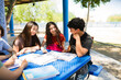 © AntonioDiaz - High school students collaborating on project outdoors