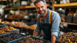 © Angger - Smiling farmer carrying dried mushrooms in warehouse
