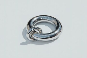 Poster - Elegant silver circular sculpture placed against a light background showcasing modern design and craftsmanship