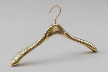 Poster - Unique golden hanger displayed on a light gray surface highlighting its smooth design and luxurious appearance