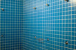 © VicVaz - empty shower cubicle interior with white grout lines in a gym