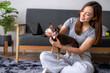 © Wasana - A woman is sitting on the floor with a small dog