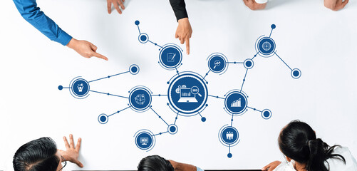 Poster - A diverse group of professionals collaborates on a digital marketing strategy, engaging in discussion around a table, with icons symbolizing analytics and business growth. Amity