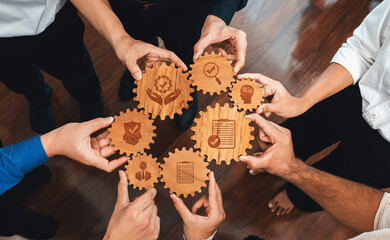 Aufkleber - This image showcases hands holding wooden gears with various icons, symbolizing teamwork, innovation, and growth in a professional environment. Amity