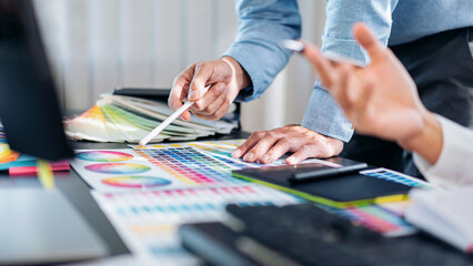 Poster - Two creative graphic designer team working on color selection and drawing on graphic tablet, Color swatch samples chart for selection coloring in inspiration to creativity at workplace