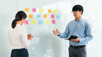 Aufkleber - Two business executive team holding and taking notes keyword on board wall to brainstorm about a new business project for planning marketing plan together in the office