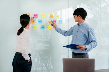 Aufkleber - Two business executive team holding and taking notes keyword on board wall to brainstorm about a new business project for planning marketing plan together in the office