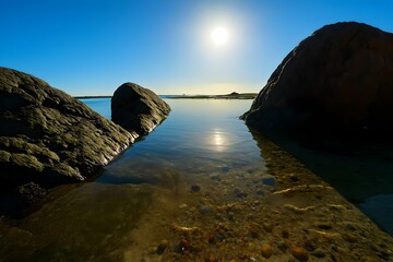 Wall Mural - Serene coastal scene with rocks and calm water.