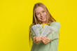 © Andrii Iemelianenko - Happy rich middle-aged woman holding fan of cash money dollar banknotes celebrate, success career, lottery jackpot casino game winner, big income, wealth, salary. Young adult girl on yellow background