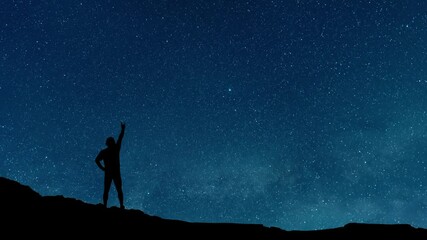 Wall Mural - hiker silhouette stands on the hill on the milky way galaxy background. night tight landscape starry