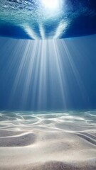 Poster - Underwater scene with sunbeams filtering through clear ocean water onto sandy seabed, creating rippling light patterns.