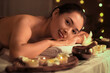© Pixel-Shot - Young Asian woman relaxing in dark spa salon, closeup