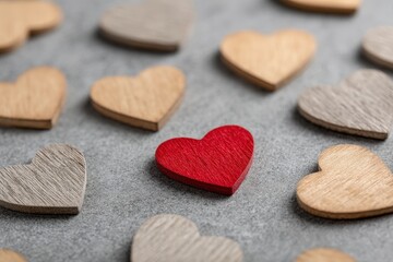 Poster - Red Heart Among Wooden Hearts On Gray Background