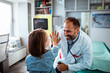 © Davor - Happy pediatrician giving high five to child patient during doctor visit in medical clinic