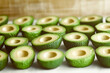 © iCreative - Freshly cut avocado halves arranged close up showing the seed cavities on a white surface for culinary and healthy eating concepts