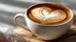 © Thamonchanok - Coffee art latte on wooden table with natural light concept. A steaming coffee cup with latte art of a heart design.