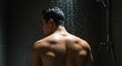 © Admint - Back View of a Muscular Man Standing in a Shower