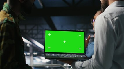 Poster - Military command center engineering team using chroma key notebook. Army IT expert and coworkers in data center using green screen laptop to defend networks against threats, camera B