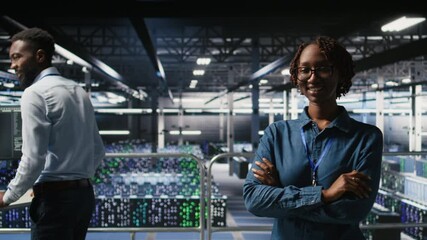 Poster - portrait of smiling data center admin next to coworkers running diagnostics on equipment to identify