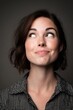 © JPminimal - Woman displaying emotion with half-smile and raised eyebrow studio portrait dramatic lighting close-up facial expression