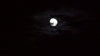 Wall Mural - Horizontal Video: Clouds moving in front of the moon.