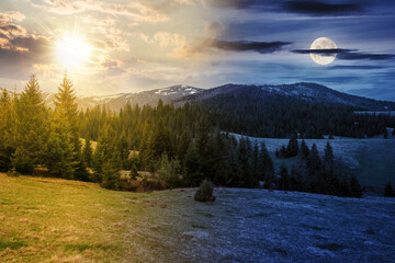 Wall Mural - day and night time change concept. countryside landscape with forested hill and snow capped mountain