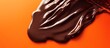 © Faris - Decadent dark chocolate melting smoothly on a vibrant orange surface creating a tempting visual