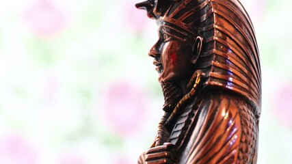 Poster - A statue of a person wearing a traditional headdress, suitable for use in historical or cultural settings