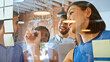 © Monkey Business - Businesswoman Writing Ideas On Glass Screen During Meeting
