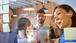 © Monkey Business - Businesswoman Writing Ideas On Glass Screen During Meeting