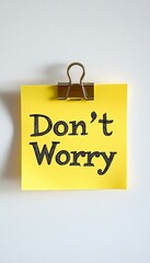 Poster - Don t Worry Note. Close Up Of Yellow Sticky Note On White Background With Inspirational Message
