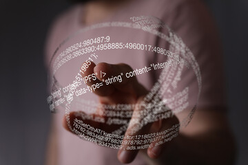 Fototapete - Close-up of a person's hand interacting with a digital sphere of code.