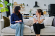 © Valerii Honcharuk - Female social worker interviewing middle aged woman, sitting together in living room
