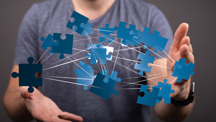 Aufkleber - Image of hands holding interconnected puzzle pieces, symbolizing teamwork, collaboration, and problem-solving.