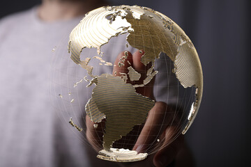 Leinwandbilder - Person's finger interacts with a digital globe, symbolizing global connections and networking.