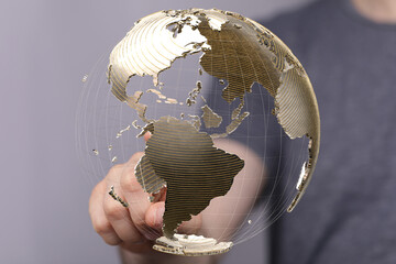Aufkleber - Hand interacting with a digital globe, representing global business, technology, and connection.