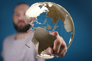 Poster - High-quality stock photo of a man interacting with a digital globe, representing global connectivity and networking.