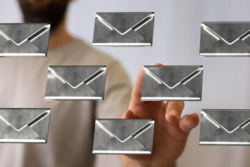 Leinwandbilder - A man's hand interacts with virtual email icons, showcasing efficient inbox management.