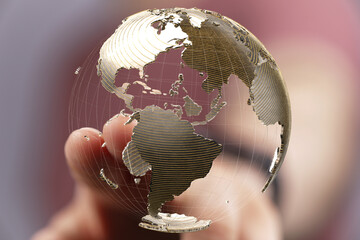 Fototapete - Abstract image of a hand interacting with a digital globe, representing global connectivity and networking.