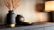 © Matthew - Elegant interior scene featuring decorative vases and a lit candle on a sleek wooden surface
